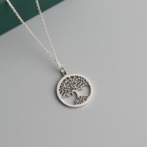 a silver tree of life pendant on a chain