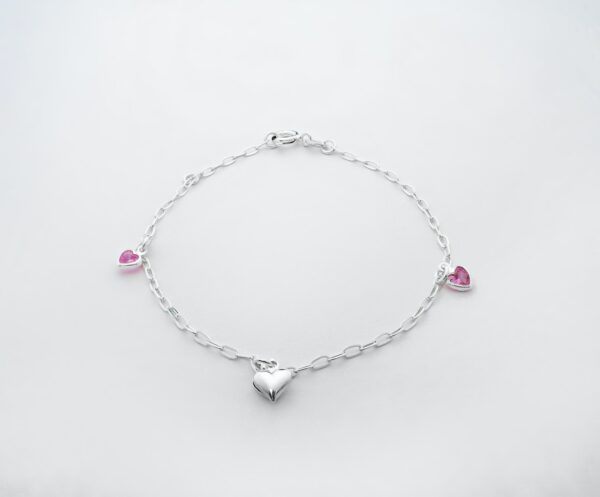 a silver bracelet with hearts and pink stones