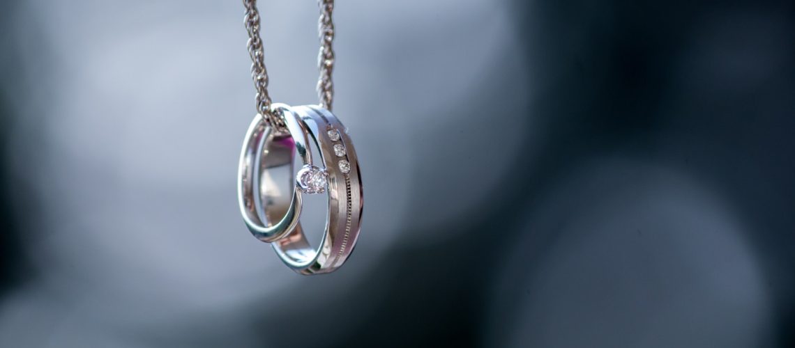 silver-colored ring pendant